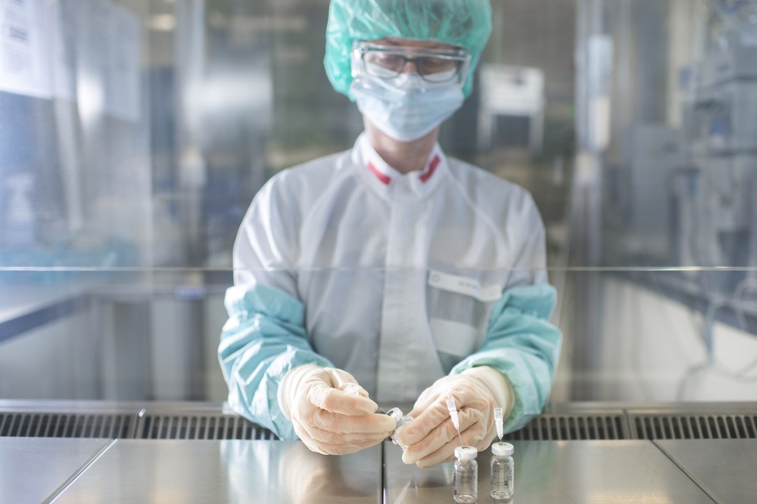 Neither dust nor germs are allowed in the clean room. Therefore pharmacist Susanne Geistlich works with sterile gloves and sleeves at a sterile work bench while she prepares non-radioactive precursors for the synthesis of a medicine. (Photo: Paul Scherrer Institute/Mahir Dzambegovic)