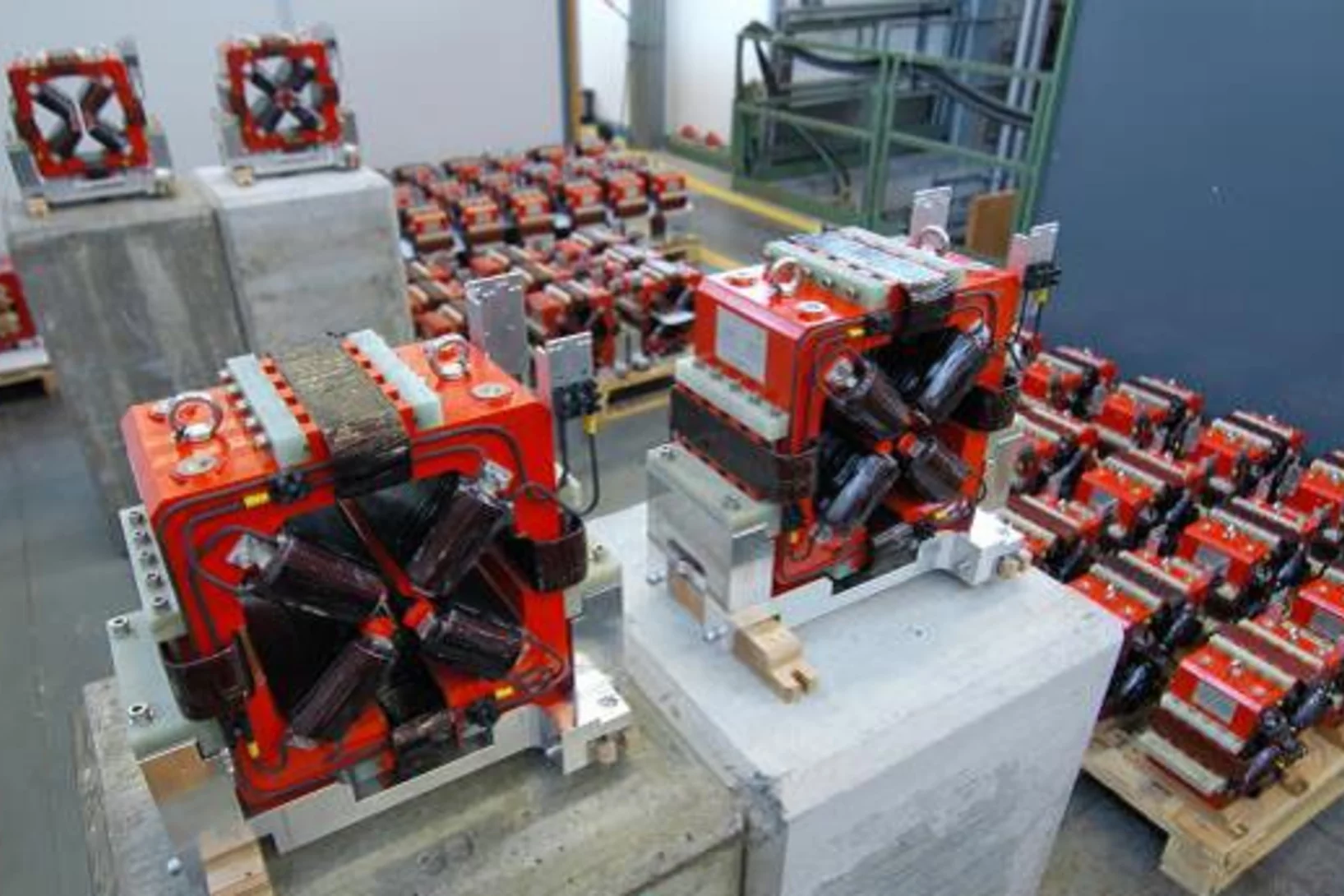 Figure 1: 22 mm aperture quadrupoles with their integrated dipole corrector coils in the assembly area of ATK before the magnetic tests.